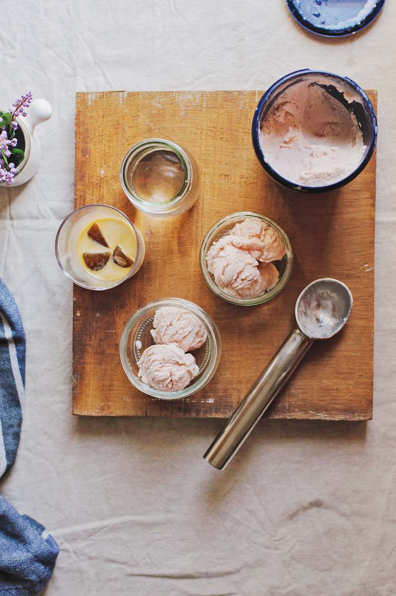 ice cream stainless steel ice cream scoop beside clear glass containers sorbet